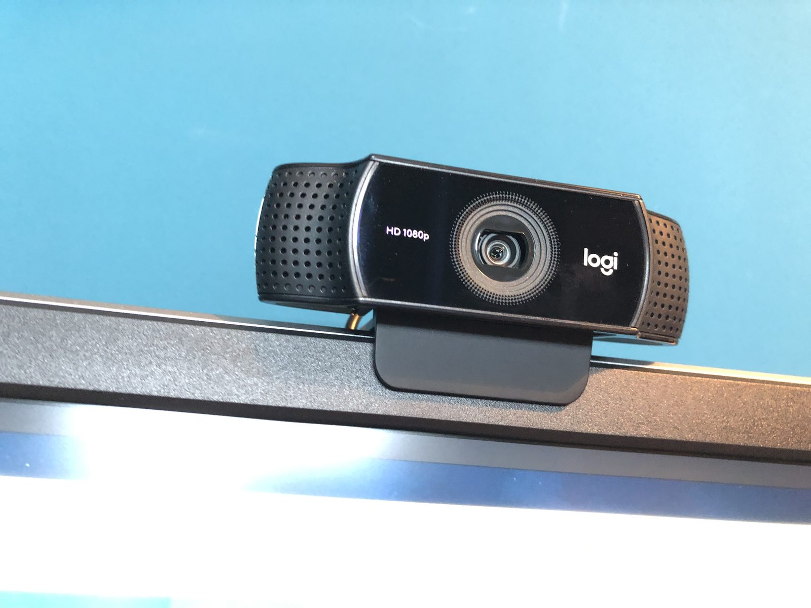 A Logitech HD 1080p webcam clipped to the top of a monitor.