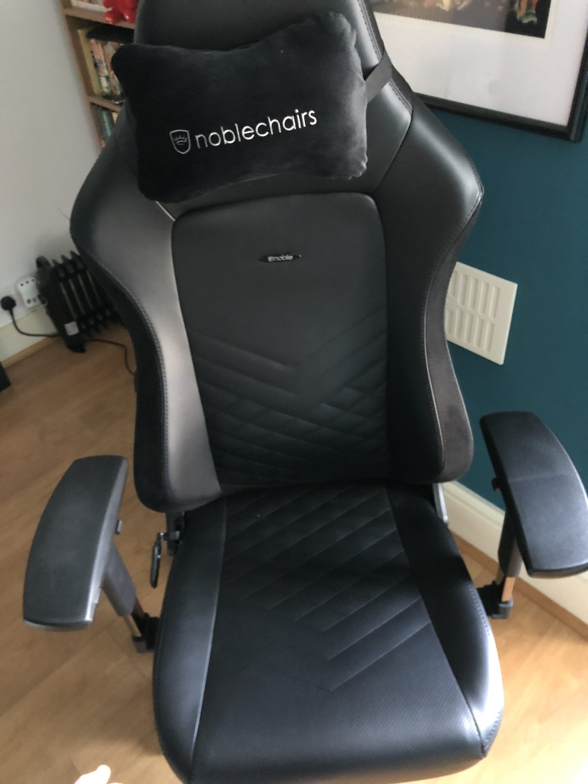 The black noblechairs Hero gaming chair in faux leather, with a branded neck pillow.